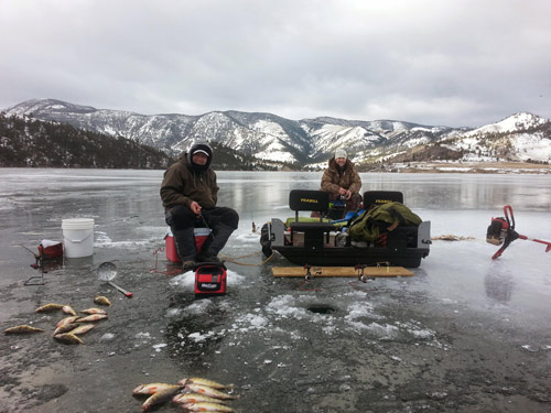Two friends ice fishing