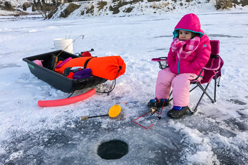 Young girl ice fishing